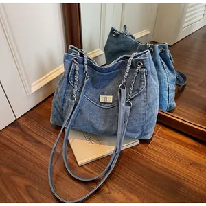 Vintage blue denim tote bag with silver chain straps and mirror reflection detail