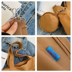 Close-up details of brown canvas tote bag including metal clasps and woven brand label.