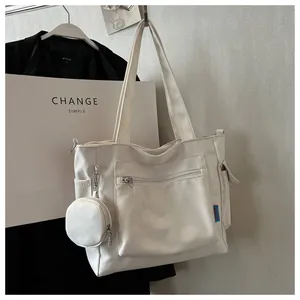 Detailed view of off-white large capacity canvas tote bag with small round pouch