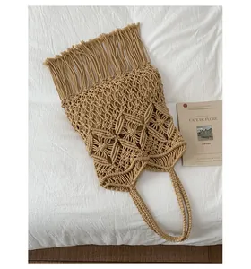 Detail shot showing the intricate weaving and tassels of a beige macrame tote bag
