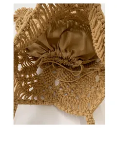 Close-up of hand-woven knit tote bag showing interior drawstring lining texture