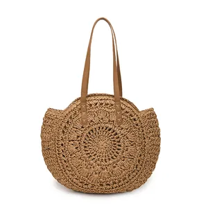 Detailed texture of a round woven paper rope bag featuring an openwork floral pattern