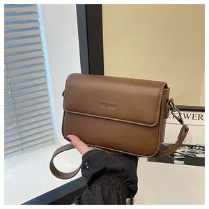 Close-up of vintage brown small square crossbody bag with textured leather