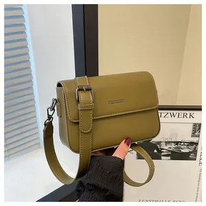 Detail view of olive green retro square crossbody bag with textured flap design