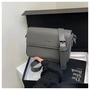 Detail showing a gray vintage minimalist square crossbody bag with decorative buckle