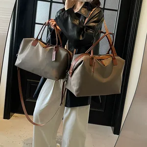 Minimalist large capacity unisex travel duffle bag in khaki color with brown leather handles