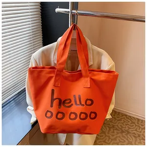 Elegante bolso tote de lona naranja con estampado hello y diseño de gran capacidad