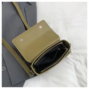 Interior detail of vintage small square crossbody bag showing zipper pocket and lining