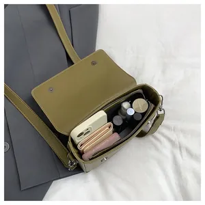 Detailed view of internal capacity in a vintage green minimalist small square bag