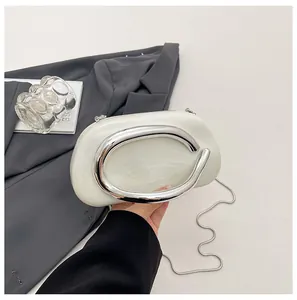 Close-up of vintage marble texture evening clutch bag with silver C-shaped metal handle.