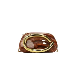 Vintage brown marble acrylic evening clutch with a bold gold C-shaped handle.