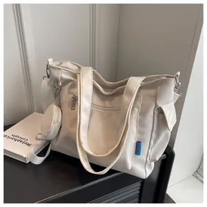 Detailed side view of a cream white large capacity canvas tote bag with pocket and purse