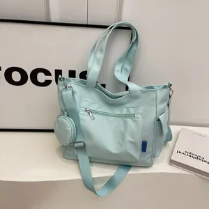 Large capacity light blue canvas tote bag with adjustable shoulder strap and small pouch