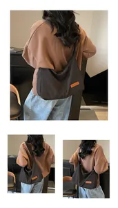 Detailed view of a large black minimalist canvas messenger bag for casual daily commuting