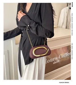 Chic burgundy evening clutch bag with gold metal buckle shown on a model wearing black
