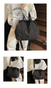 Veelzijdige zwarte nylon tas met trekkoord getoond in hand- en crossbody-stijlen