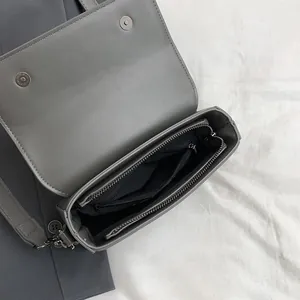Vintage minimalist grey square crossbody bag with functional internal compartments detail.
