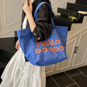 Bolso tote informal de lona azul de gran capacidad con estampado de letras naranjas