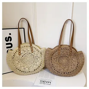 Detailed view of two elegant round hollow floral straw bags in beige and light brown colors.