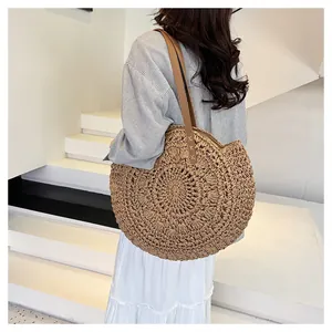 Large round paper rope woven shoulder bag with detailed texture and straps