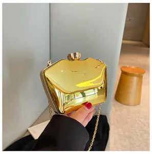 Close-up view of a shiny gold acrylic clutch evening bag with an elegant chain strap
