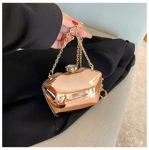 Detailed close-up of a rose gold acrylic evening clutch featuring a crystal clasp and gold chain
