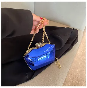 Fashionable blue glossy acrylic evening clutch bag with elegant gold chain strap detail