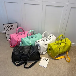 Detailed view of fashion travel bags in five vibrant colors with crocodile texture