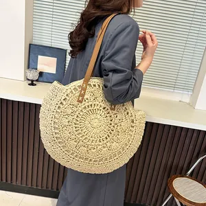Round woven straw shoulder bag with hollow flower pattern for casual summer beach fashion