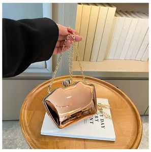 Shiny rose gold mirror finish acrylic clutch bag with elegant gold chain strap detail