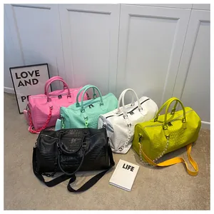 Group of colorful crocodile embossed faux leather travel bags for gym and weekend trips