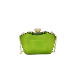 Vibrant green acrylic evening clutch bag with crystal clasp and elegant gold chain strap