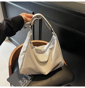 Minimalist large capacity off-white messenger bag shown in a lifestyle setting
