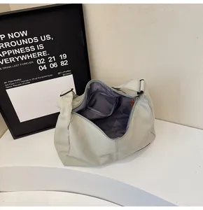 Minimalist light green hobo shoulder bag showing its spacious interior with zipper pocket.