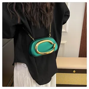 Premium emerald green evening clutch with large gold buckle and crossbody chain strap