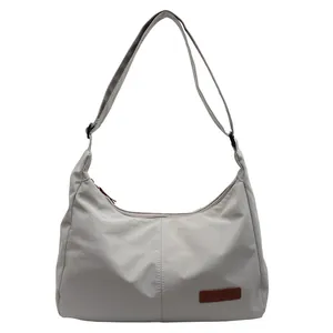 Large capacity light grey nylon crossbody messenger bag with adjustable shoulder strap