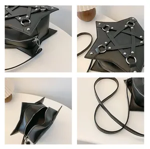Detailed view of black star-shaped crossbody bag with studded straps and silver hardware