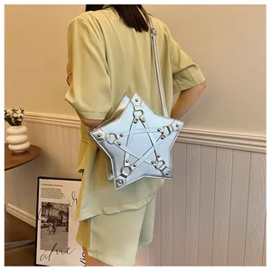 Back view of a silver star-shaped crossbody bag worn with a green outfit stylish.