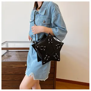 Model wearing a unique black five-pointed star-shaped crossbody bag with silver rings