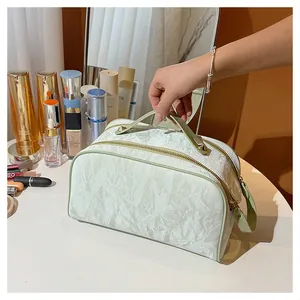 Lifestyle shot of large capacity mint green cosmetic bag on a vanity