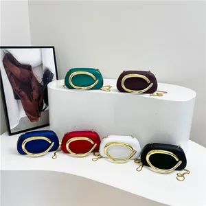 Elegant evening clutch bags with large gold horseshoe handle available in six colors