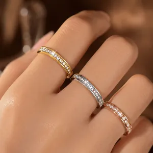Close-up view of shimmering gold, silver, and rose gold eternity rings with zirconia.