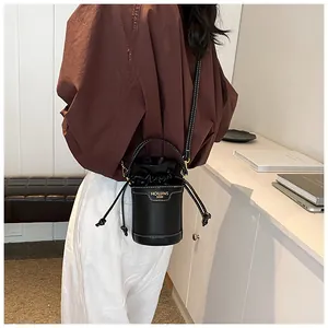 Stylish black leather drawstring bucket bag for women, elegant cylindrical shoulder bag