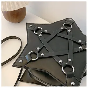 Close-up of black star-shaped crossbody bag with silver rivets and pentagram design