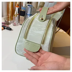 Close-up of mint green crinkled texture cosmetic bag with embossed YOUBEISHI logo detail