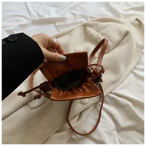 Detailed interior view of a minimalist brown drawstring bucket bag with clean lining