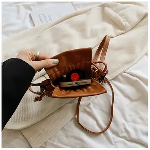 Detailed interior view of brown drawstring bucket bag showing ample storage space