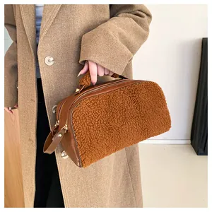 Large brown fleece handbag with textured sherpa and faux leather details in lifestyle shot