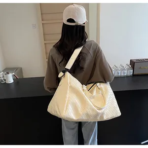 Large white woven leather travel bag for women, high-capacity fitness and weekend tote bag.
