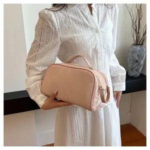 Handheld large capacity light pink cosmetic storage bag with elegant textured surface design